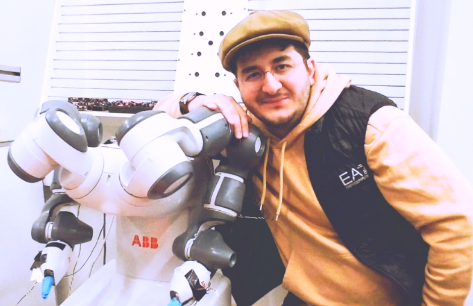 Ahmed Al-Irhayim beside an ABB YuMi robot